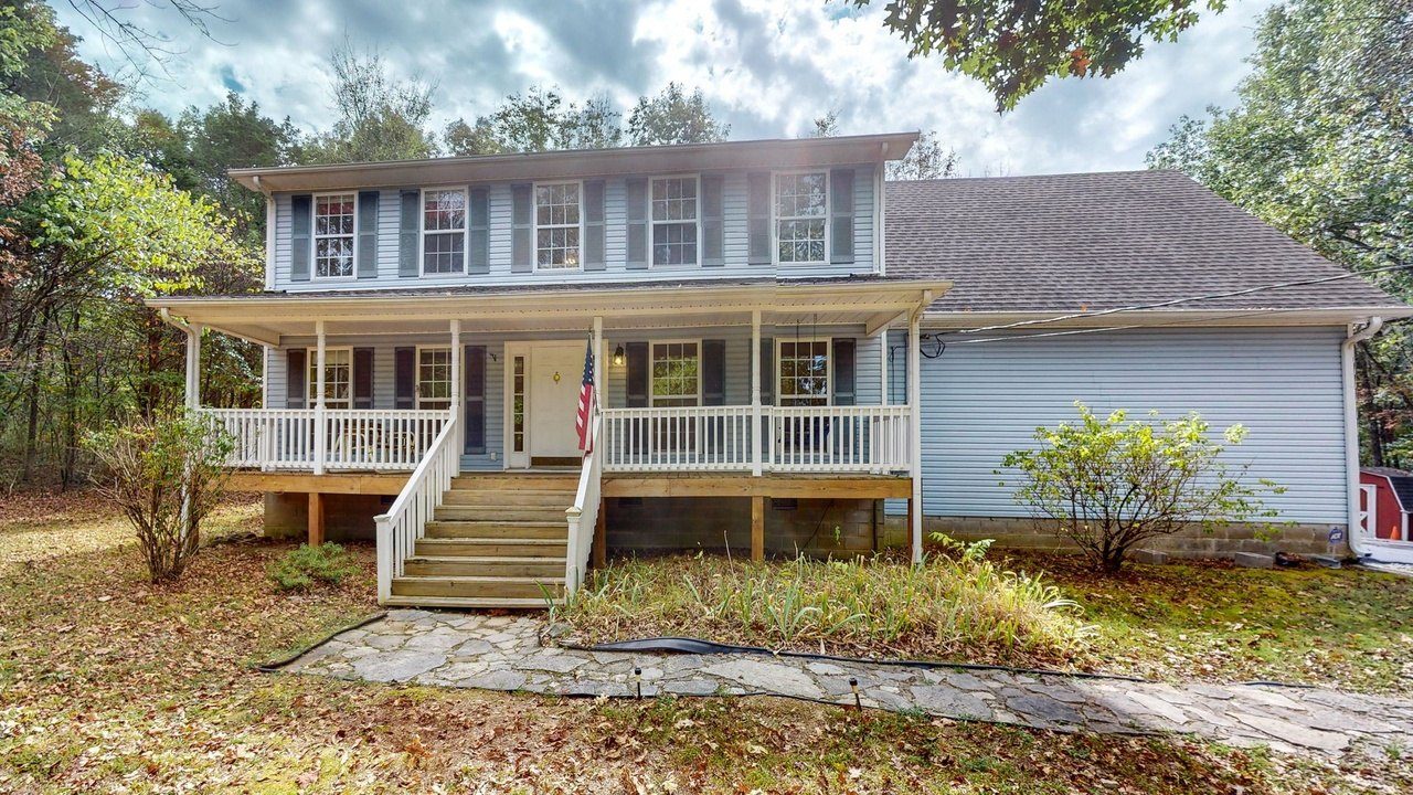The house in October 2023, with the flag on the front porch